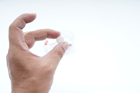 Hands Holding Pills medicine on white backgroundの写真素材