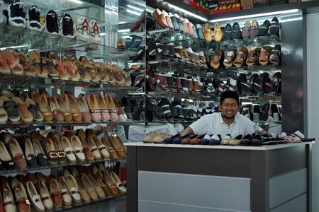 Banda Aceh, Indonesia - May 30, 2019: Vendor Selling Shoes and sandals at street footwear shop in Banda Aceh capital cityのeditorial素材