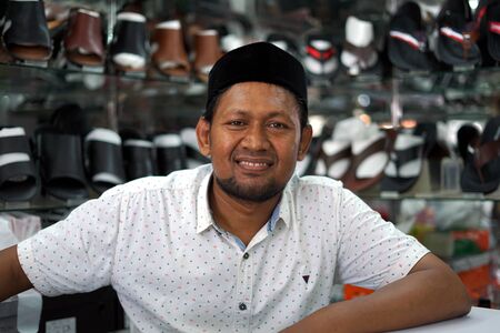 Banda Aceh, Indonesia - May 30, 2019: Vendor Selling Shoes and sandals at street footwear shop in Banda Aceh capital cityのeditorial素材