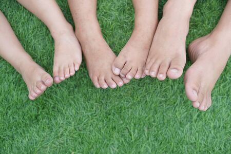 Happy Child's feet on the green grassの写真素材