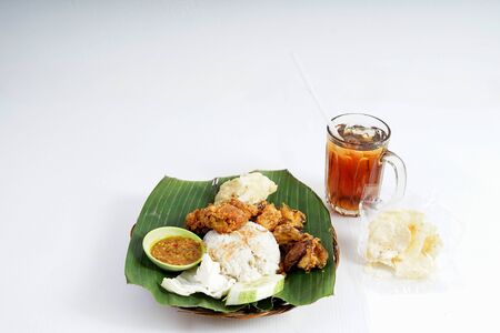 Tasty Asian Ayam Penyet or smashed fried chicken with Ice Tea from Indonesiaの写真素材