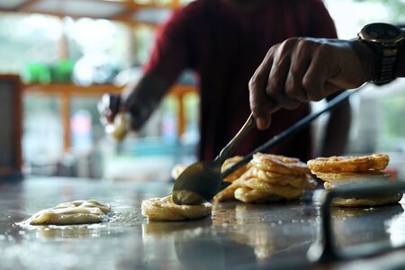 Street food vendor stirring Martabak Aceh in big panの写真素材