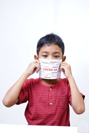 schoolboy holding COVID-19 coronavirus signの写真素材