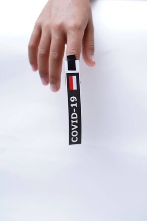 Hand with Covid-19 sticker. Conceptual image for Stop the coronavirus spreading