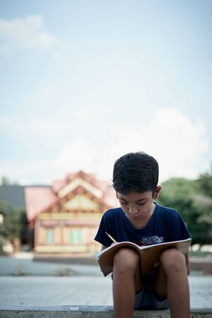 Little boy writing and studying at home, study from home during a coronavirus