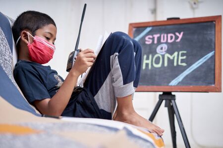 cute little boy study and playing walkie-talkie at home during a coronavirus Diseaseの写真素材