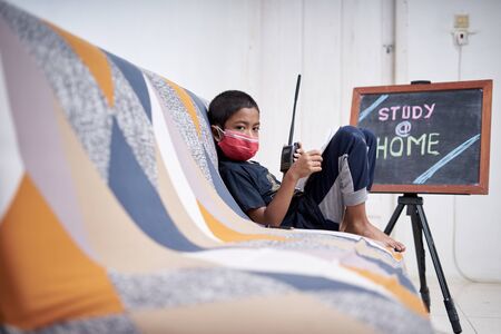 cute little boy study and playing walkie-talkie at home during a coronavirus Disease