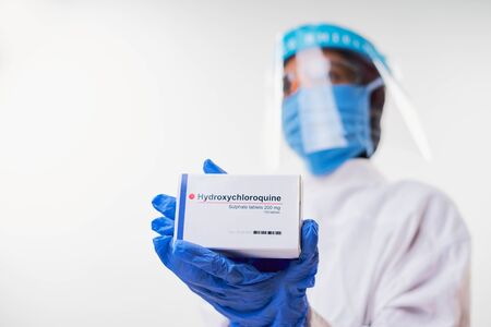 Female doctor holding Hydroxychloroquine (Chloroquine) Medicine for coronavirus treatmentの写真素材