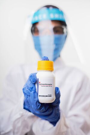 Female doctor holding Hydroxychloroquine (Chloroquine) Medicine for coronavirus treatment