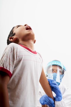 Scared Little boy get vaccination injection. Concept of prevention world coronavirus pandemicの写真素材