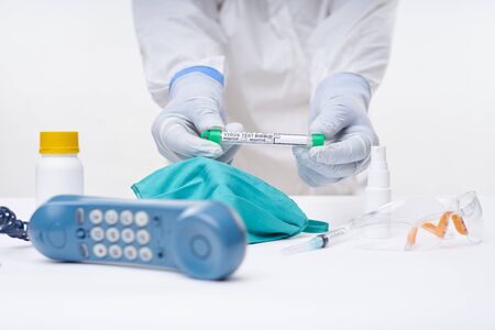 Doctor holding Test tube for Swab test and ready for covid-19 exams