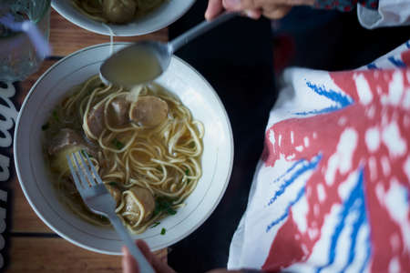 Meatballs with Noodle Soup on table at street food marketの写真素材