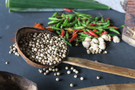 Various spice on wooden spoons with herbsの写真素材