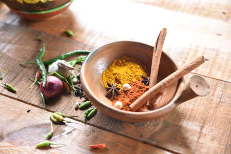 Variety of spices and herbs on kitchen wooden tableの写真素材
