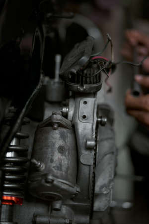 Closeup man hands repairing retro motorcycle