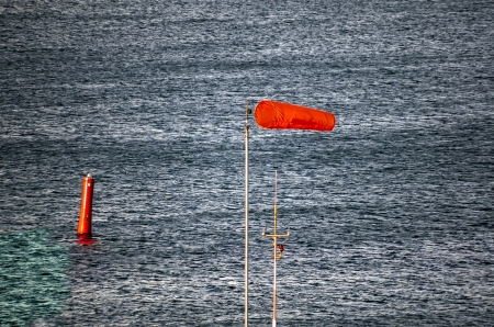Blue steel water before storm with red bouy and airtubeの写真素材