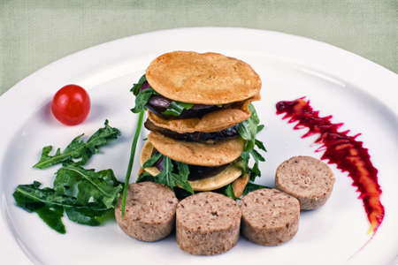 restaurant dish consisting of sausage with pancakes lined slideの写真素材