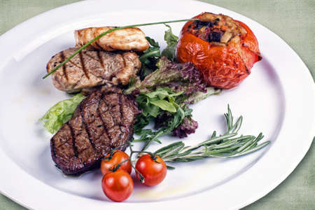 restaurant dish consisting of roasted meat with vegetablesの写真素材