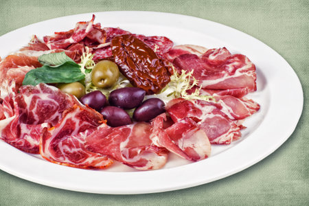 restaurant dish consisting of meats with olivesの写真素材