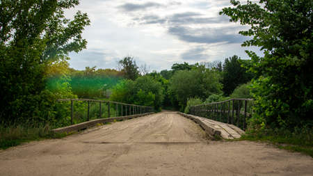 Vintage wooden bridge over the river in the countrysideの写真素材