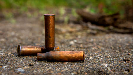 Three old brown bullet casings close upの写真素材