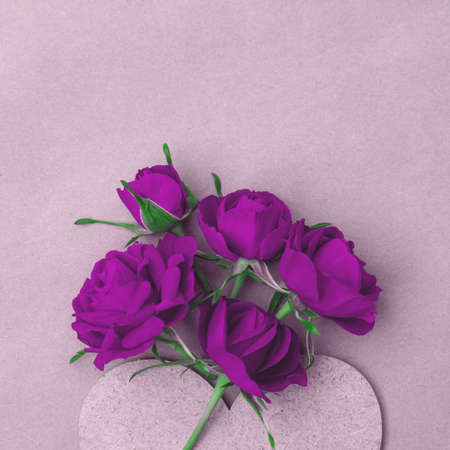 Bouquet of purple bright roses with a heart. Postcard with place for design.の写真素材