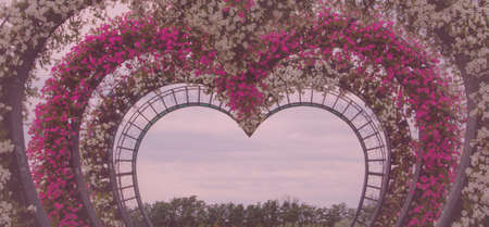 Photo zone arch with flowers in the form of a heart