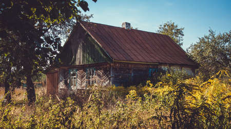 Old abandoned ruined wooden house in the countryside