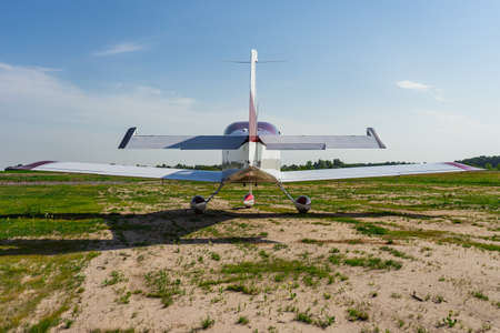 Small modern private jet before the flight against the backdrop of nature.の写真素材