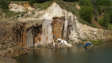 Abandoned basalt quarry. Basalt faceted rocks.の写真素材