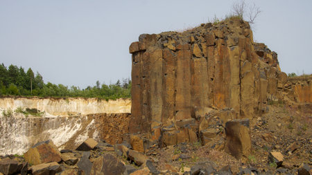 Abandoned basalt quarry. Basalt faceted rocks.