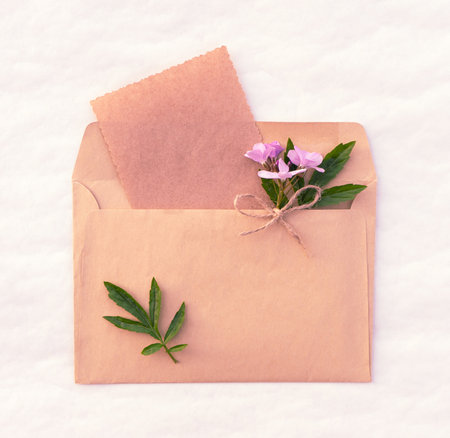 Spring card with a bouquet of pink flowers in an envelopeの写真素材