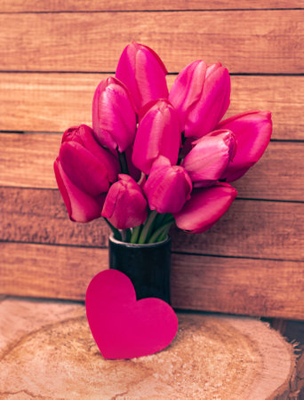 romantic card with a large bouquet of bright red tender tulipsの写真素材