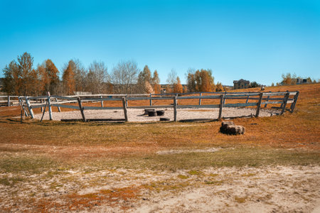 Animal pen on a horse farm with a wooden fenceの写真素材