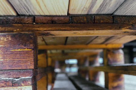 Carpentry made of rough wood, perspective view from below.