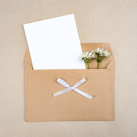 Stylish greeting card with a bouquet of wild flowers in an envelopeの写真素材