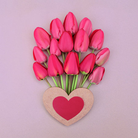 romantic card with a large bouquet of bright red tender tulipsの写真素材