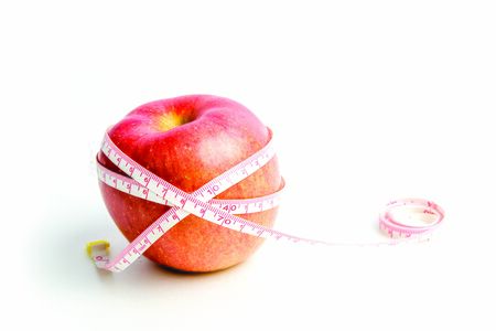 Apple with measuring tape
