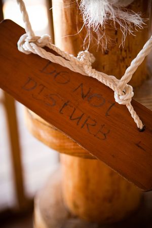 Do not disturb sign made of wood haging from postの写真素材