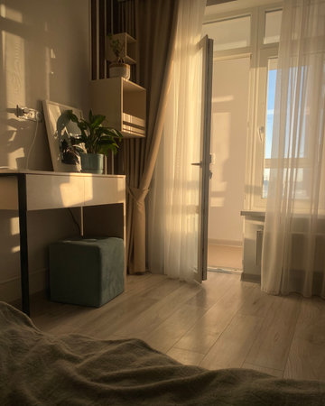 Interior of a living room with a window and a bedside tableの写真素材