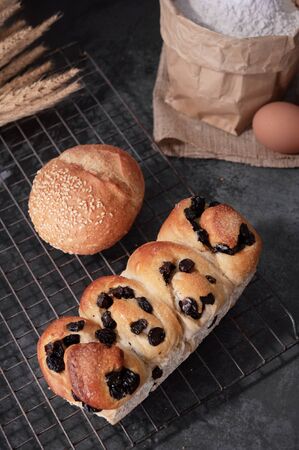 Homemade bread with eggs and bag of flour on gray background.の写真素材