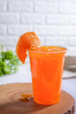 Orange smoothie on a wooden. Beverage fruitの写真素材