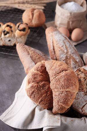 Homemade traditional bread with eggs and bag of flour on gray backgroundの写真素材
