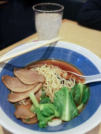 Japanese ramen soup with duck and chopsticks.の写真素材