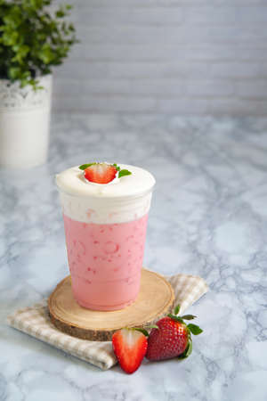 Strawberry milk shake on top cream cheese in glass plastic.の写真素材