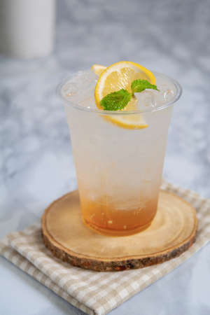 Honey lemon soda with ice in glass plastic.の写真素材