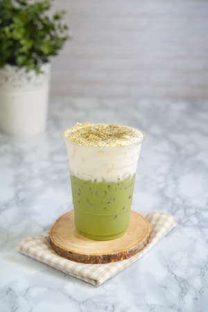 Milk green tea on top cream cheese in glass plastic.の写真素材