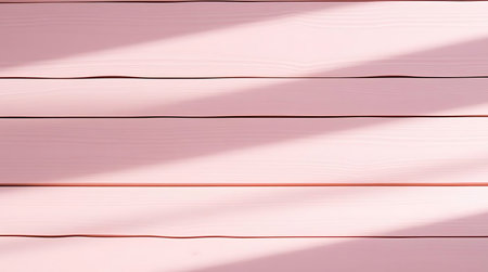 Pink wooden background with sunlight and shadow. Top view.の素材