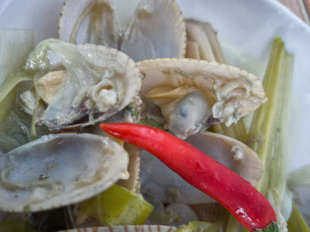 Simple dish of Asian saltwater clam with chilli, lemongrass and garlic in clear broth. Selective...