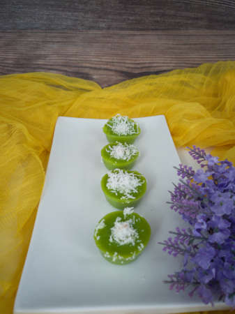 Steamed Pandan Rice Cake or locally known as Kuih Lompang or Kuih Kasui with desiccated coconut on top. Selective focus points. Blurred backgroundの写真素材
